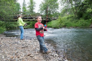 Marcus Larson/News-Register<br/>
Grayson Goings and his mother, Courtney, enjoy a day of fishing at Willamina Creek in Blackwell Park. Several of the county parks have water access.