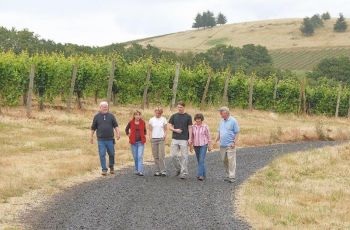 <b>Ted Castell (far left), his wife, Pat Dudley, and their daughter, Mimi, walk the vineyard with family members Terry Castell (far right), his wife, Marilyn Webb, and their son, Ben.</b>